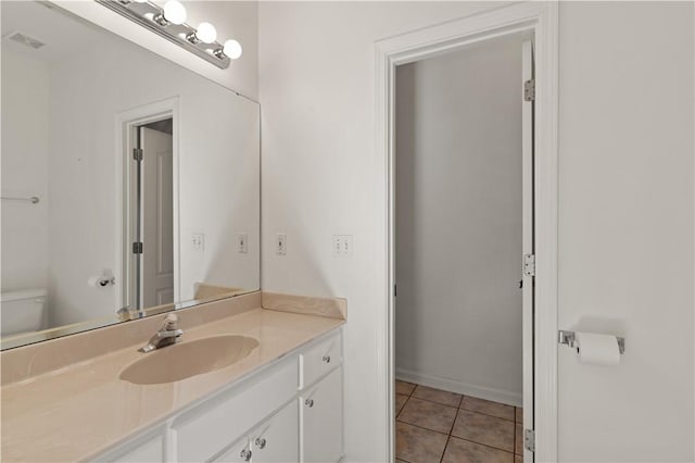 bathroom with tile patterned floors, toilet, and vanity