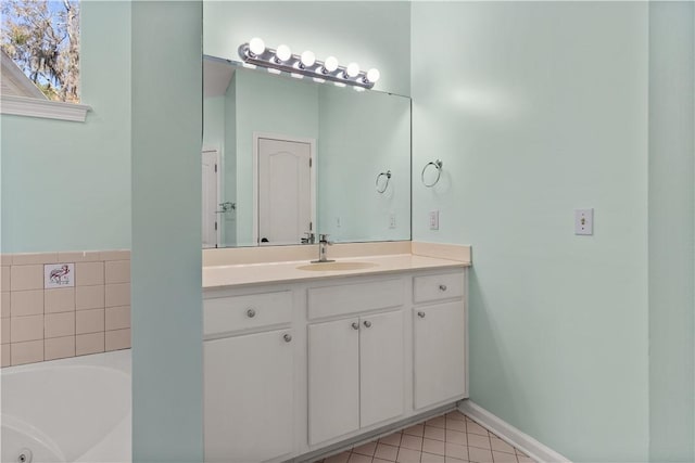 bathroom with tile patterned flooring, vanity, and a tub