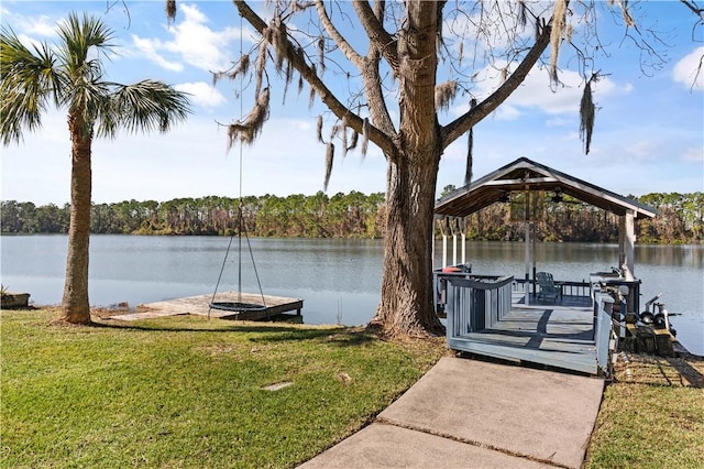 dock area with a lawn and a water view