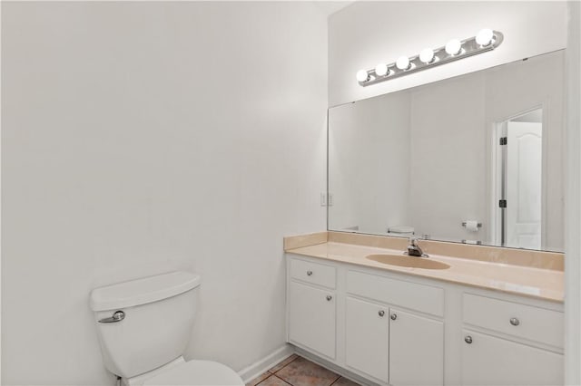 bathroom with vanity, tile patterned floors, and toilet