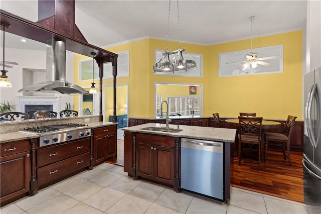 kitchen with appliances with stainless steel finishes, sink, island range hood, and pendant lighting