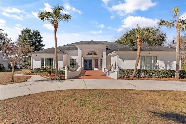 view of front of home with a front lawn and french doors