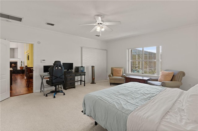 bedroom featuring crown molding, carpet floors, and ceiling fan