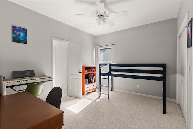 bedroom featuring light carpet and ceiling fan