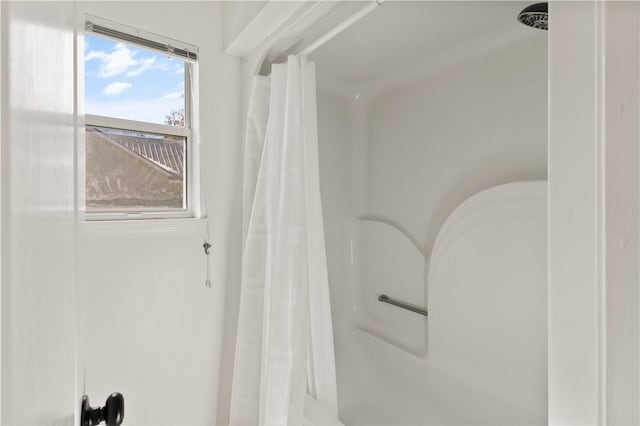 bathroom with a shower with curtain and a wealth of natural light