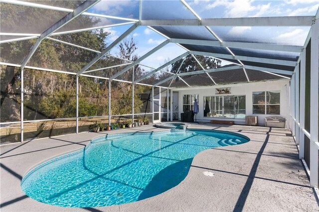 view of swimming pool with glass enclosure and a patio area