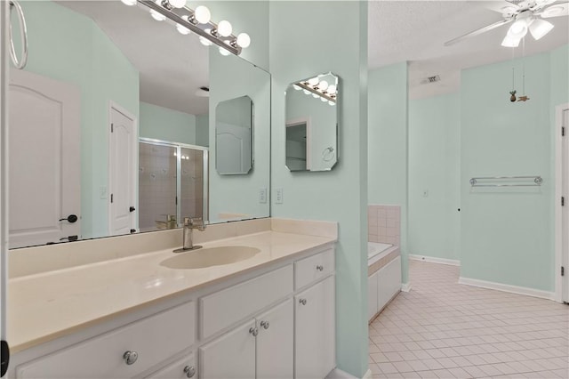 bathroom featuring vanity, separate shower and tub, ceiling fan, tile patterned floors, and a textured ceiling