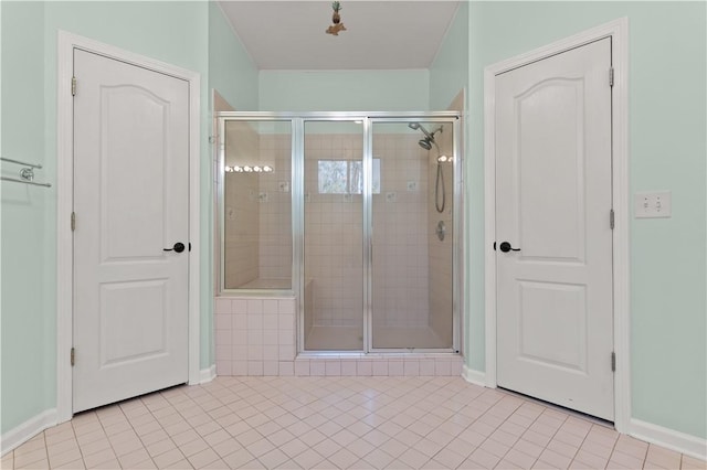 bathroom featuring tile patterned flooring and an enclosed shower