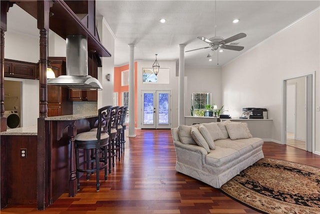 living room featuring crown molding, ceiling fan, dark hardwood / wood-style flooring, washer / dryer, and french doors