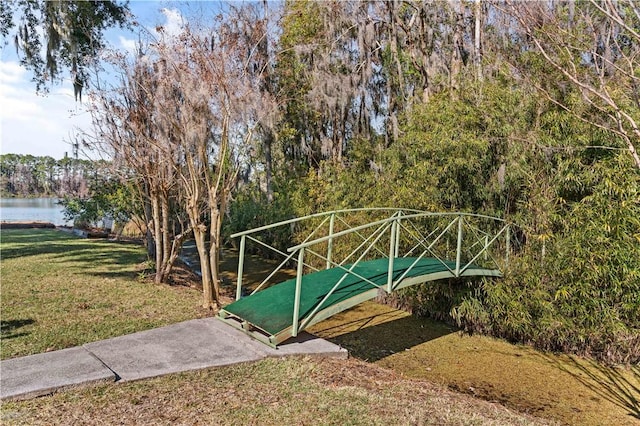 exterior space with a lawn and a water view