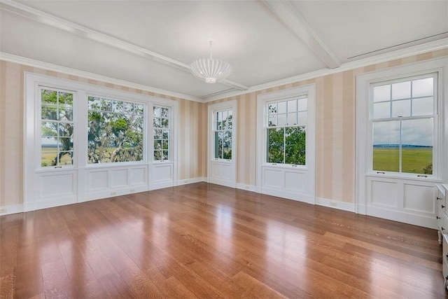144 Point Ln, Saint Simons Island, GA 31522 - empty room with a chandelier, wood finished floors, healthy amount of natural light, crown molding, and baseboards