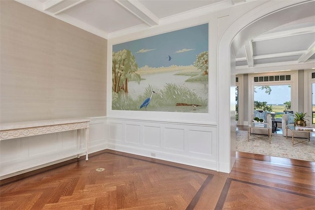 144 Point Ln, Saint Simons Island, GA 31522 - empty room featuring coffered ceiling, beam ceiling, a wainscoted wall, and arched walkways