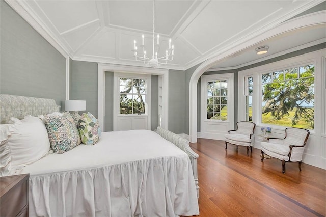 144 Point Ln, Saint Simons Island, GA 31522 - bedroom with a chandelier, crown molding, wood finished floors, coffered ceiling, and arched walkways