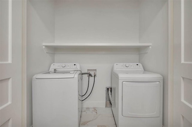 144 Point Ln, Saint Simons Island, GA 31522 - laundry area with light marble finish flooring and washing machine and dryer