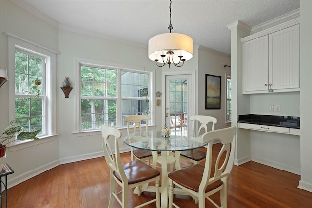 11 Niblick Ct, Saint Simons Island, GA 31522 - dining area with healthy amount of natural light, wood finished floors, ornamental molding, and a textured ceiling