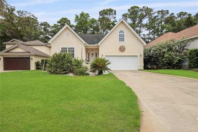 11 Niblick Ct, Saint Simons Island, GA 31522 - view of front of house with stucco siding, a front yard, driveway, and an attached garage