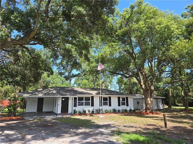 554 Blythe Island Dr, Brunswick, GA 31523 - view of front of house with driveway, a carport, and board and batten siding