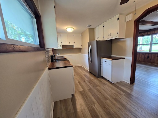 554 Blythe Island Dr, Brunswick, GA 31523 - kitchen with white cabinets, wood finished floors, a ceiling fan, stainless steel fridge with ice dispenser, and tasteful backsplash