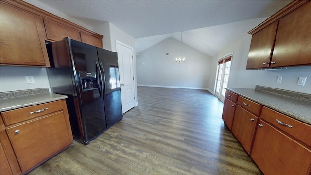 kitchen featuring black fridge, an inviting chandelier, dark hardwood / wood-style flooring, and vaulted ceiling