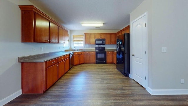 kitchen featuring sink, black appliances, and dark hardwood / wood-style floors