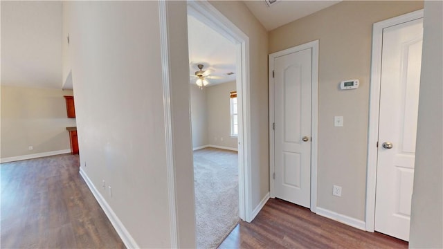 hallway with dark hardwood / wood-style flooring