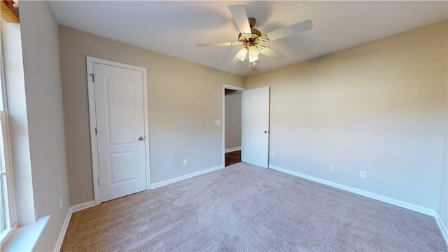 unfurnished bedroom with carpet floors and ceiling fan