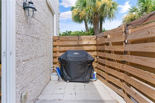 view of patio featuring area for grilling and fence