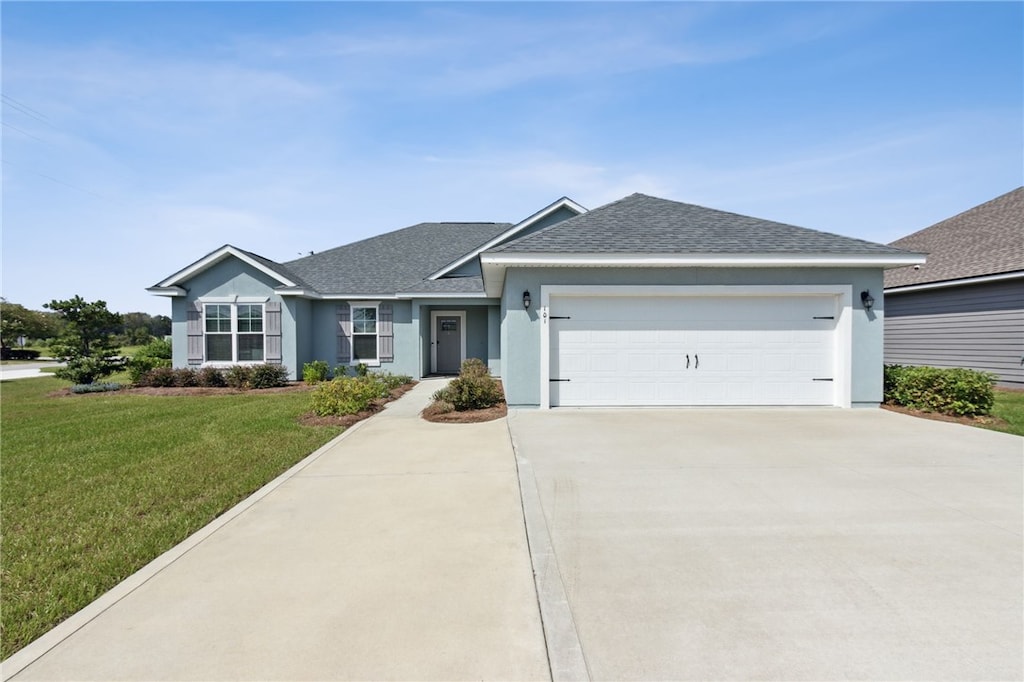 ranch-style house with a garage and a front lawn