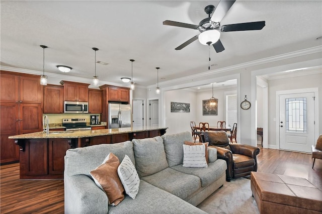 living room with ornamental molding, ceiling fan, and dark hardwood / wood-style flooring