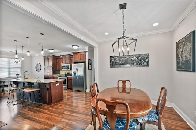 dining space with dark hardwood / wood-style flooring, sink, and ornamental molding