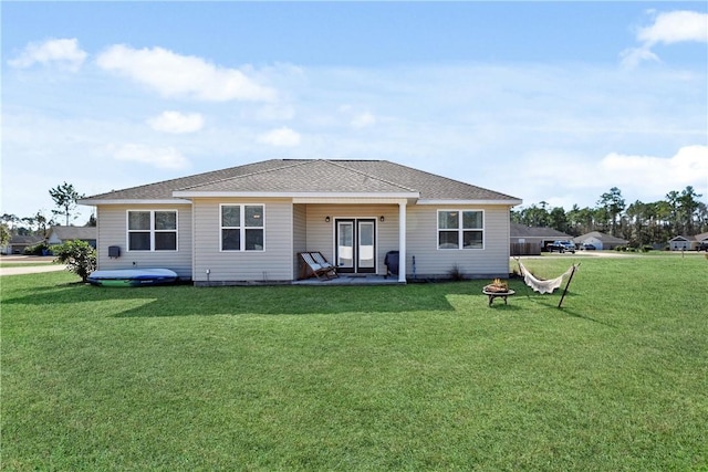 back of house with a lawn