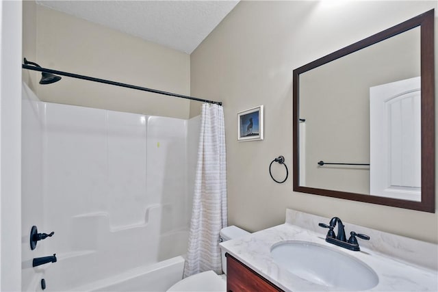 full bathroom with vanity, shower / bath combo, toilet, and a textured ceiling