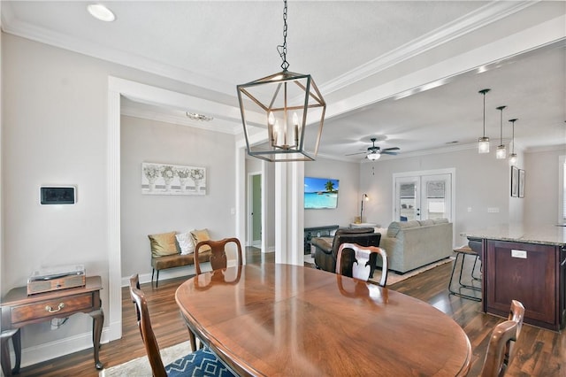 dining area with crown molding, dark wood-type flooring, ceiling fan, and french doors