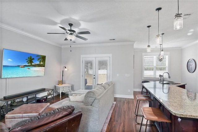 living room with sink, crown molding, ceiling fan, dark hardwood / wood-style floors, and french doors