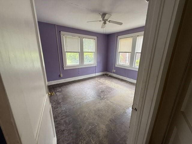 511 Riverside Dr, Waycross, GA 31501 - unfurnished room with baseboards, a ceiling fan, and concrete floors