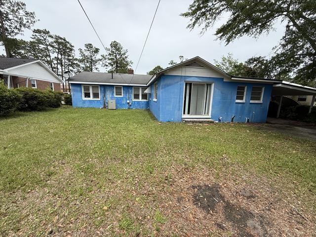 511 Riverside Dr, Waycross, GA 31501 - rear view of property with a carport and a yard