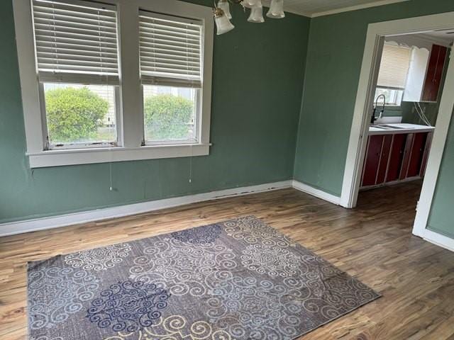 511 Riverside Dr, Waycross, GA 31501 - unfurnished dining area featuring wood finished floors, baseboards, healthy amount of natural light, and ornamental molding