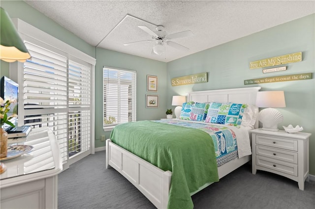 carpeted bedroom with a textured ceiling and ceiling fan