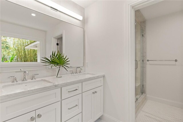 bathroom with a shower stall, baseboards, double vanity, recessed lighting, and tile patterned floors