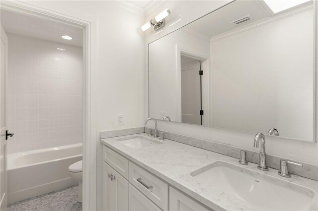 bathroom with toilet, crown molding, double vanity, and shower / washtub combination