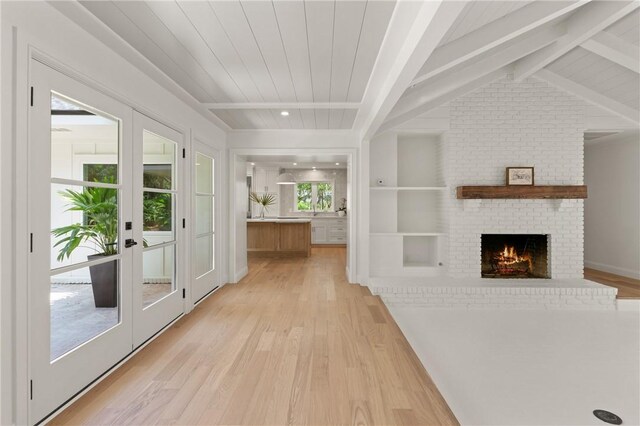 unfurnished sunroom with french doors and beamed ceiling