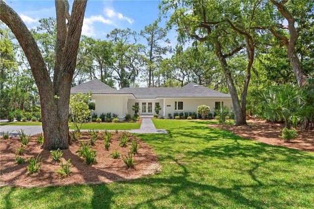 ranch-style home with french doors and a front yard
