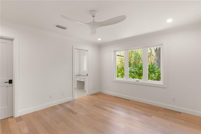 unfurnished bedroom with ornamental molding, light wood-type flooring, baseboards, ensuite bath, and recessed lighting