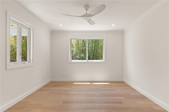 spare room with ornamental molding, ceiling fan, light wood finished floors, baseboards, and recessed lighting