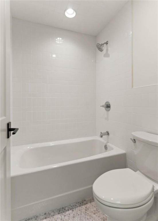 bathroom with toilet, shower / bath combination, and recessed lighting