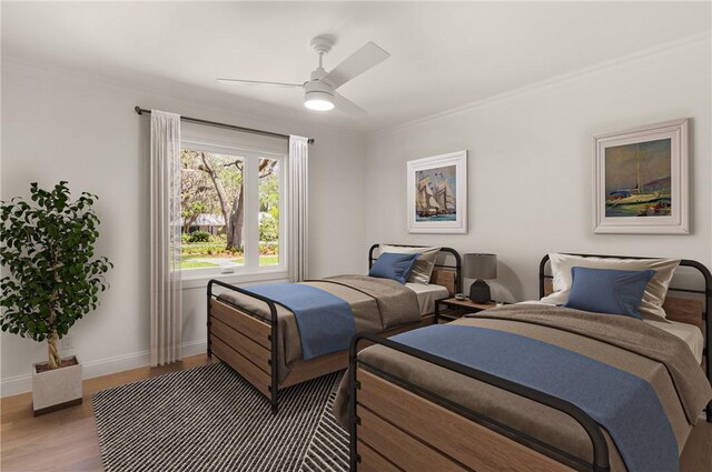 bedroom with wood finished floors, baseboards, ceiling fan, and crown molding