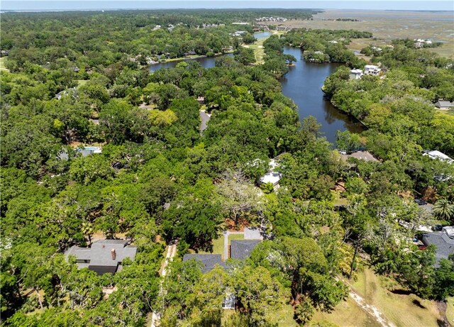 aerial view of a nearby body of water and a heavily wooded area