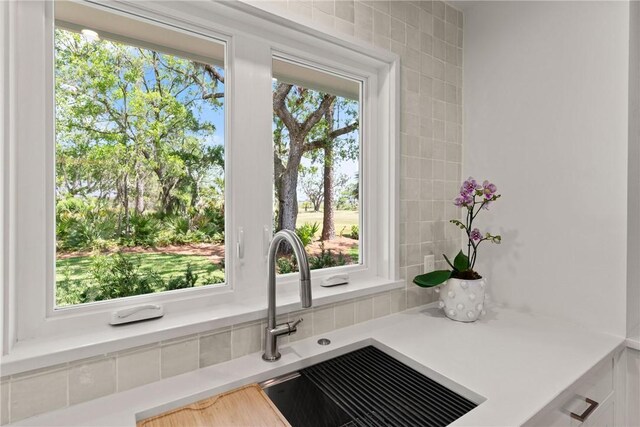 kitchen view of light countertops and a sink