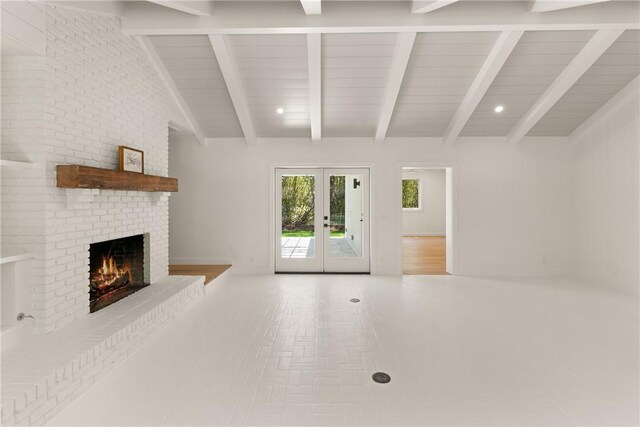 unfurnished living room with a fireplace, french doors, and wood ceiling