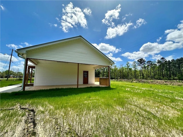 rear view of house with a lawn and a patio area